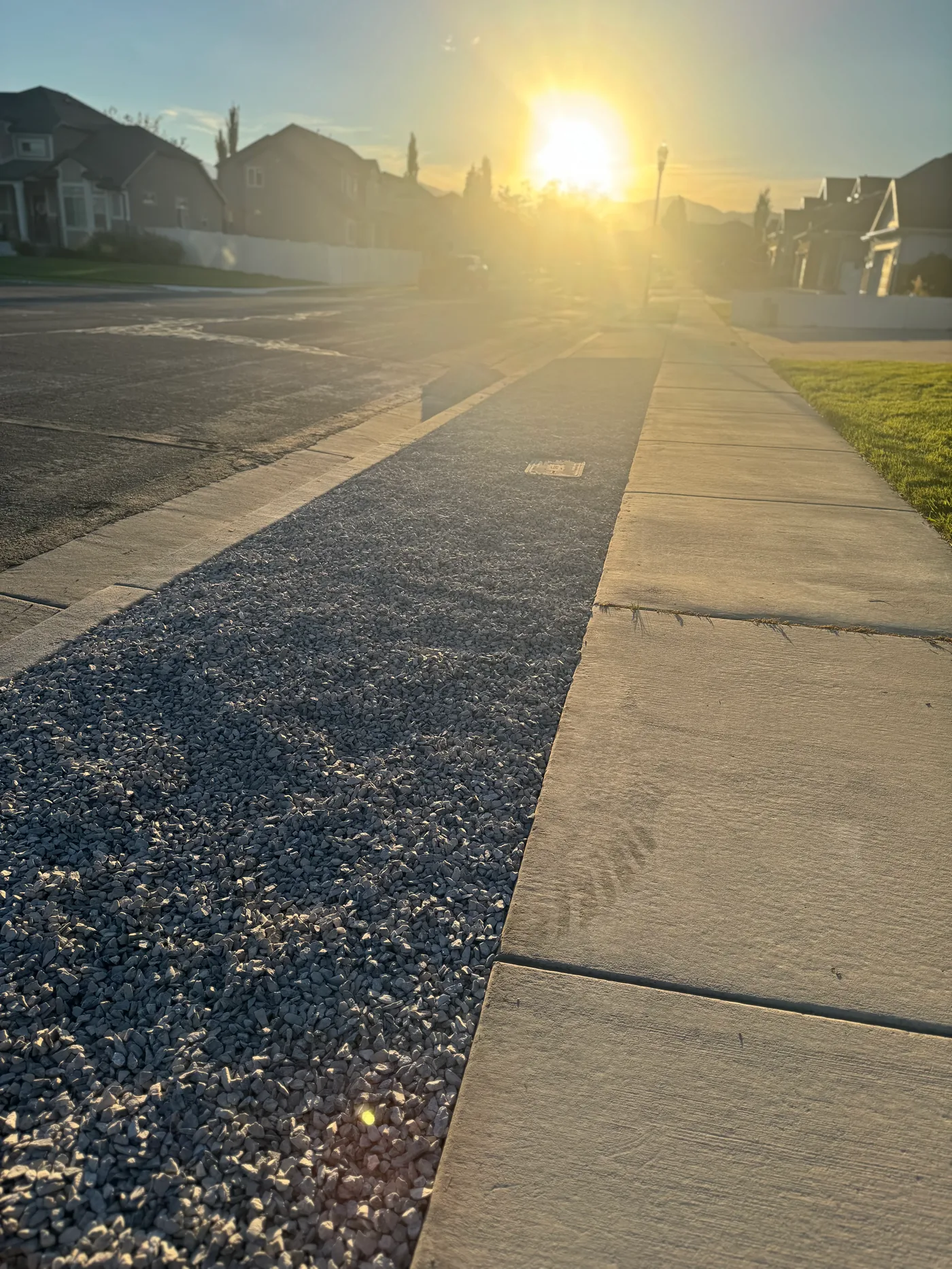 Riverton parking strip before and after — rock and weed barrier landscaping
